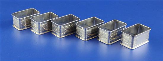 A matched set of six George V silver rectangular napkin rings, 3.5 oz.